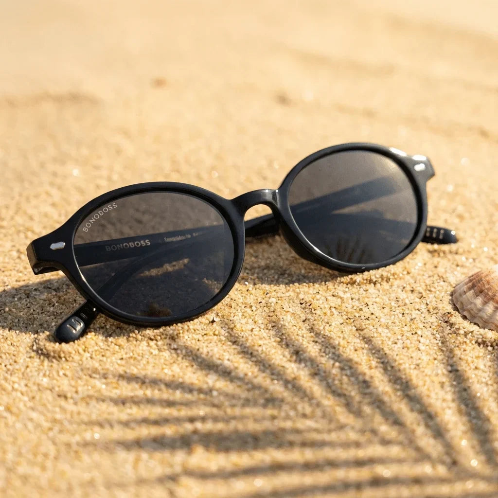 Lentes sol Capri polarizados UV400 sobre arena dorada costa textura natural Bonoboss #color_negro