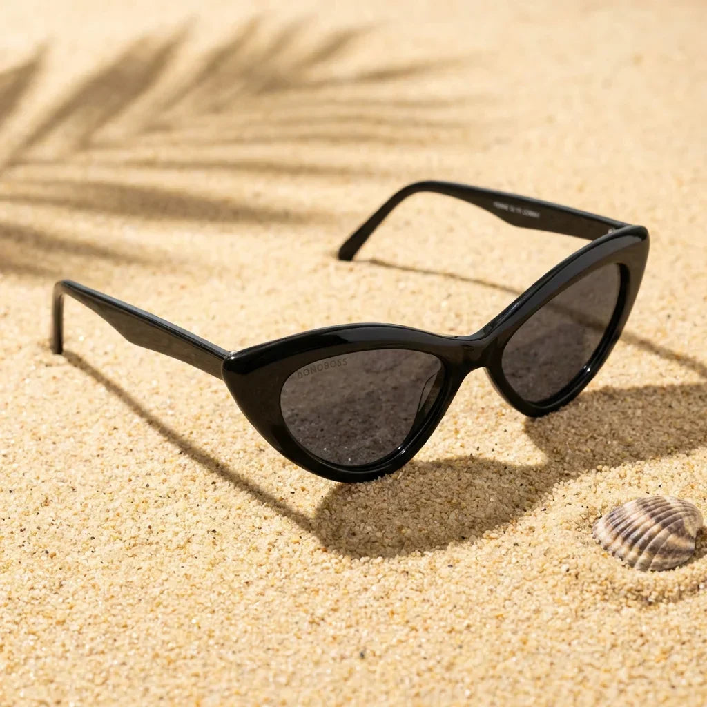 Lentes sol Femme Black polarizados UV400 sobre arena dorada costa textura natural Bonoboss #color_negro