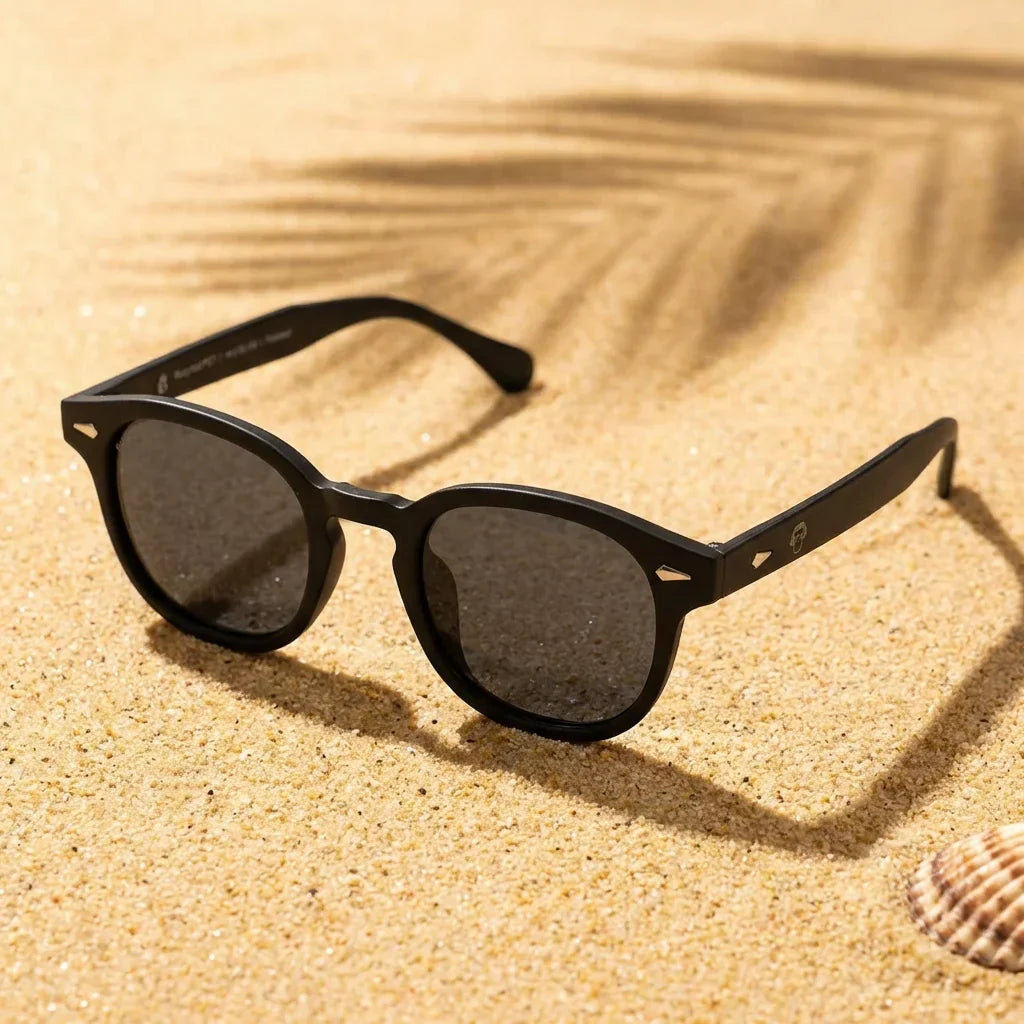 Lentes sol Waimea RPET polarizados UV400 sobre arena dorada costa textura natural Bonoboss #color_negro