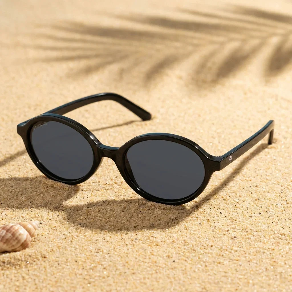 Lentes sol Guapi Island polarizados UV400 sobre arena dorada costa textura natural Bonoboss #color_negro