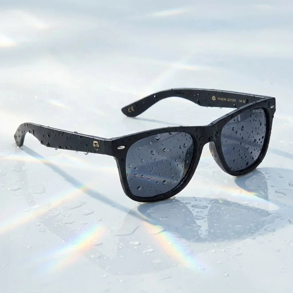 Lentes sol Acacia Dark polarizados UV400 sobre superficie con agua y luz natural Bonoboss #color_negro