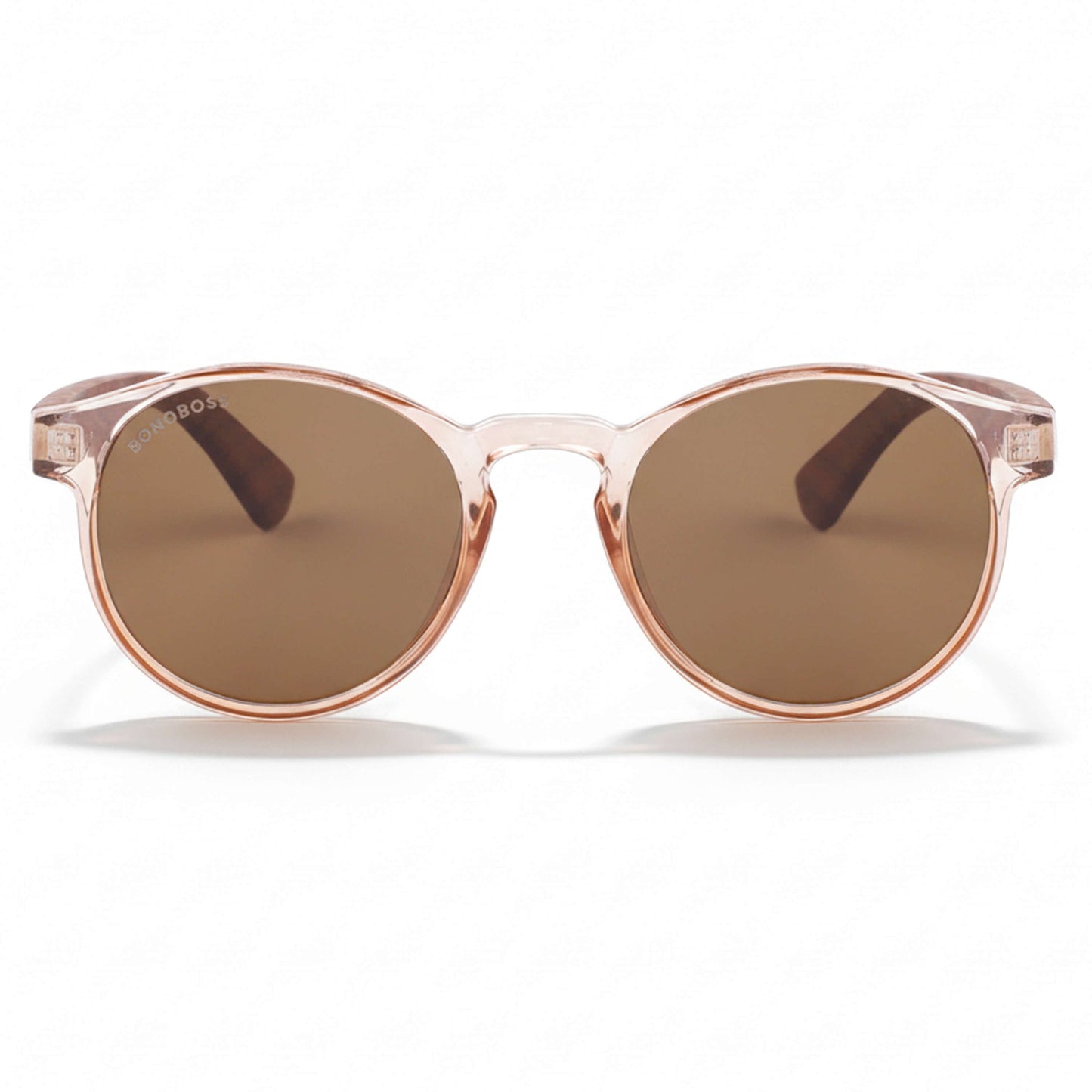 la vista frontal de unos anteojos anteojos gafas de sol polarizadas de forma redonda y con puente para narices anchas hechas de plastico reciclado sustentable ecologico personalizada y patas de madera de #color_rosa