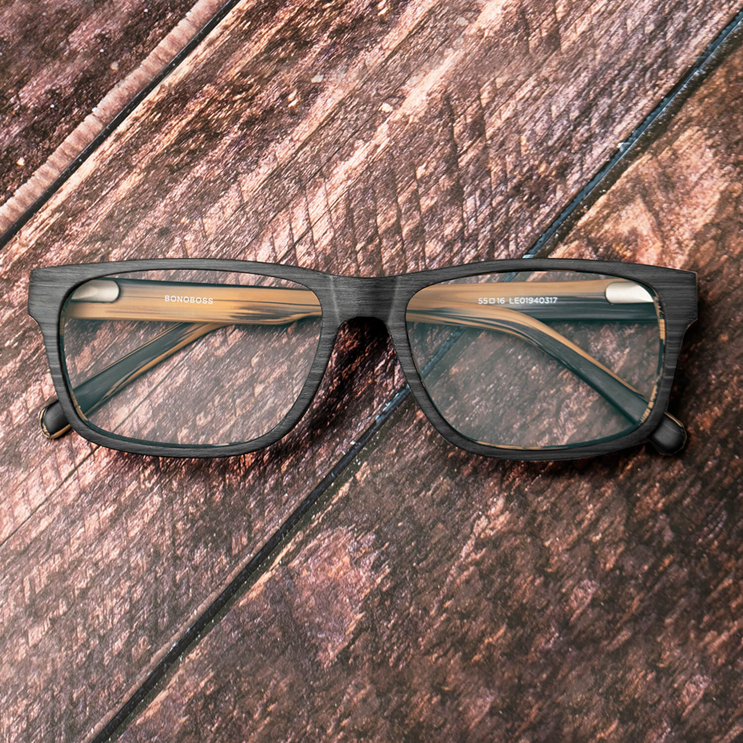 vista frontal de armazones o marcos opticos de material sustentable reciclado ecologico de forma rectangular de color negro para hombre y mujer de cara redonda#color_gris