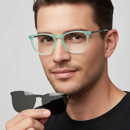 un hombre de cara ovalada usando armazones opticos grandes con clip de sol polarizado #color_green