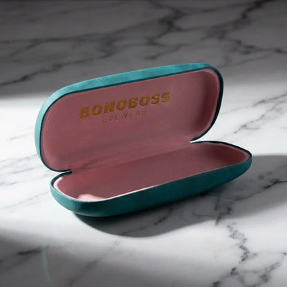 Estuche almeja para lentes calipso abierto sobre mármol Bonoboss #color_calipso