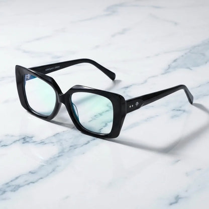 Lentes ópticos Domi Negro sobre mármol blanco elegante armazón premium Bonoboss #editorial_armazon #color_negro