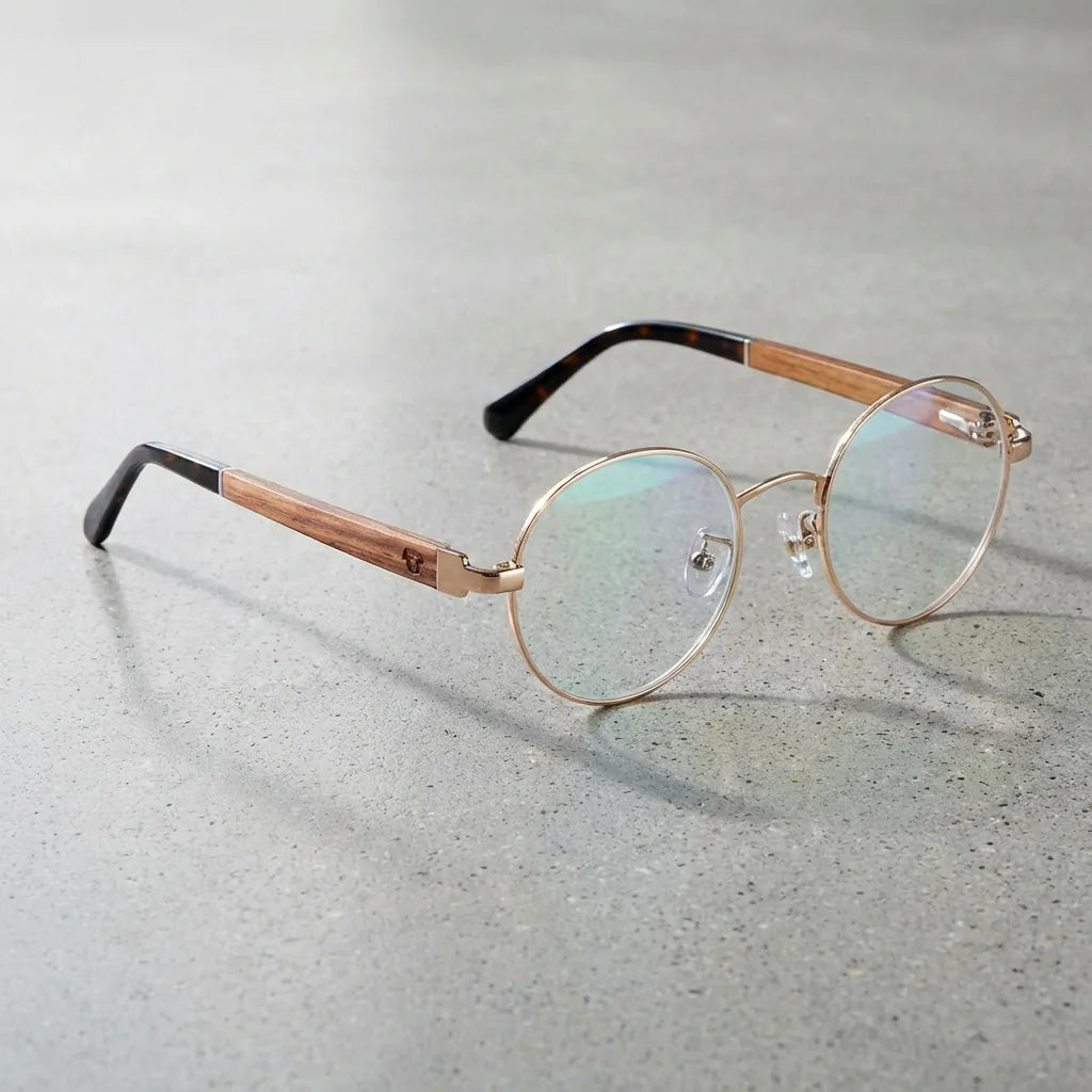 Lentes ópticos Harry Dorado sobre concreto pulido minimalista armazón premium Bonoboss #editorial_armazon #color_dorado