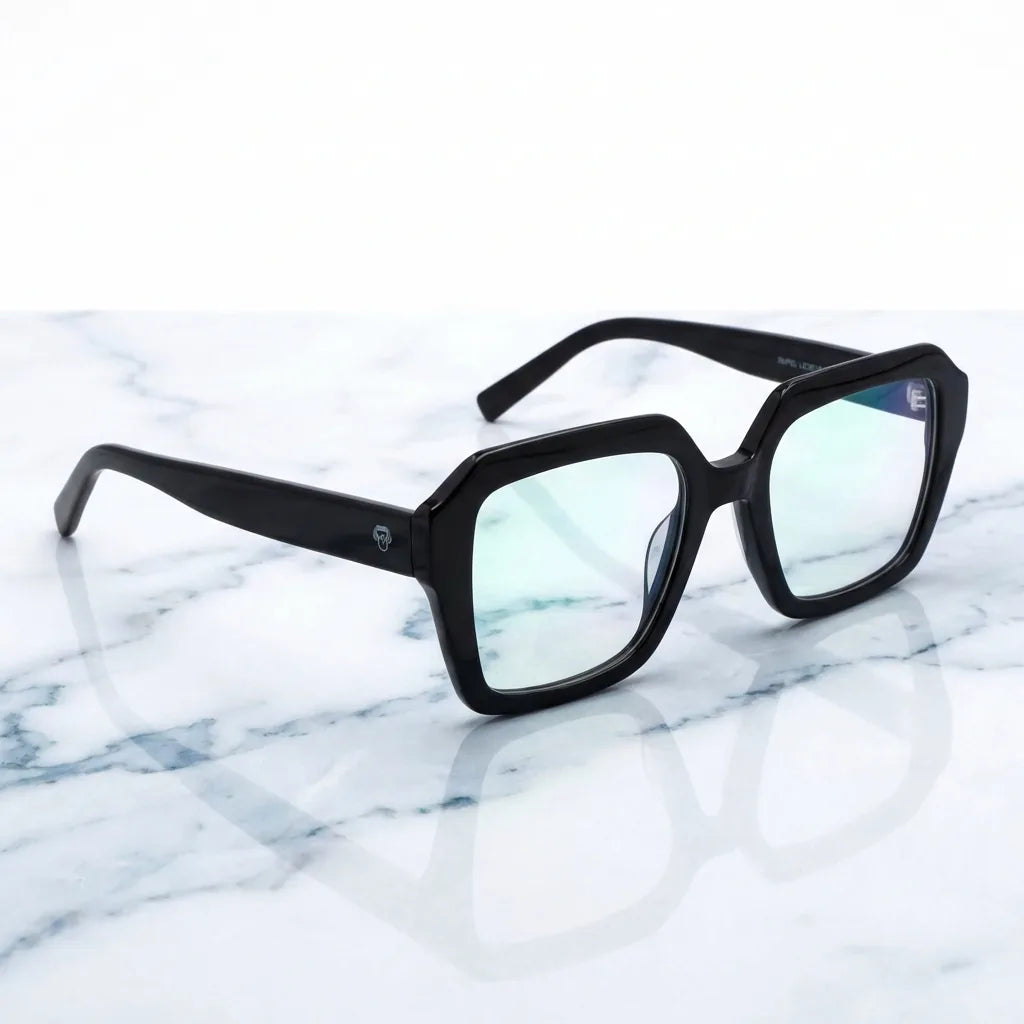 Lentes ópticos Rapel Negro sobre mármol blanco elegante armazón premium Bonoboss #editorial_armazon #color_negro