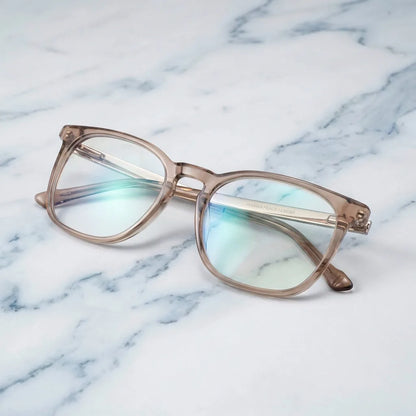 Lentes ópticos Waimea Steel Optic Champagne sobre mármol blanco elegante armazón premium Bonoboss #editorial_armazon #color_champagne