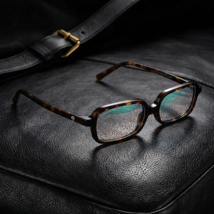 Lentes opticos Navarino Carey sobre cuero negro con detalle brass dorado antirreflex receta optica bio-acetato Bonoboss #editorial_cuero-brass #color_carey